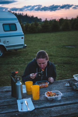 Hungrily eating.