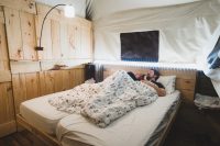 The platform tents can sleep six people. There’s a room with a king-size bed, a cabinet bed for two, and another room with a bunk bed. We illuminated our room with the provided solar laterns as well as a set of string LEDs.