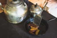 Preparing a morning meal on the wood cookstove.