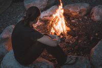 Mesmerized by the bonfire after a day of swimming and exploring.