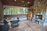 Adjacent to the pool house is an outdoor entertainment area complete with fireplace.