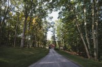 The approach to the property starts to set the stage for its wooded seclusion.