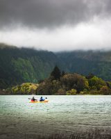 Some folks kayaking in the lagoon surrounded by beauty.