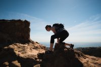 Scrambling on the rocks at the top of Temescal Canyon Trail in Topanga State Park in Los Angeles, California.