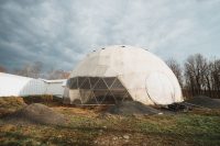 This greenhouse illustrates aquaponics and, in the future, will produce biogas via anaerobic digestion to sustain the property on renewable energy.