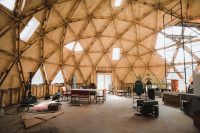 The geodesic dome (with a passive solar design) serves as the community gathering area. It is the future home of a shared kitchen and bathroom.