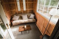 The Ravens Nest living area opens onto the deck overlooking the pond.