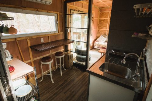 Can you believe this? The Ravens Nest not only has electric and hot water but also has a kitchenette with sink, stove, coffee maker, propane grill, and breakfast bar. Perfect to sit at and gaze outside at the pond.