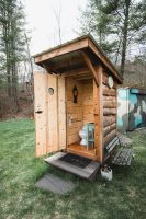 The lower level of the property has a gorgeous bathroom. You simply can't call this an outhouse.